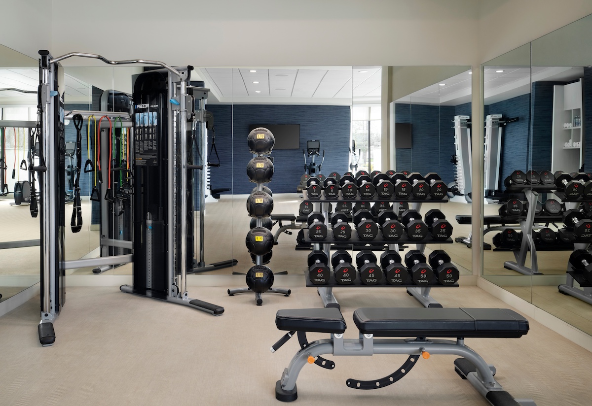 Weight rooms with medicine balls, bench, free weights and cable machine