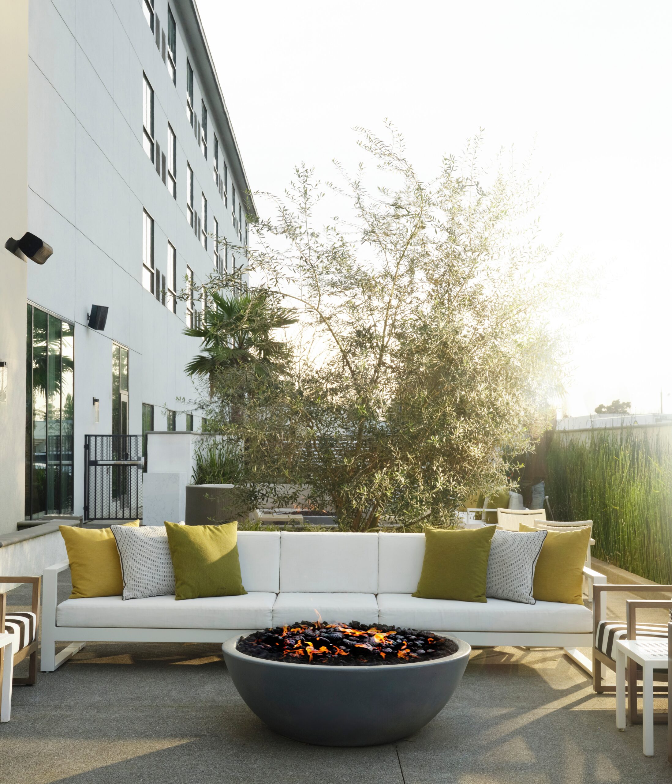 Exterior couch and fire pit at sunset