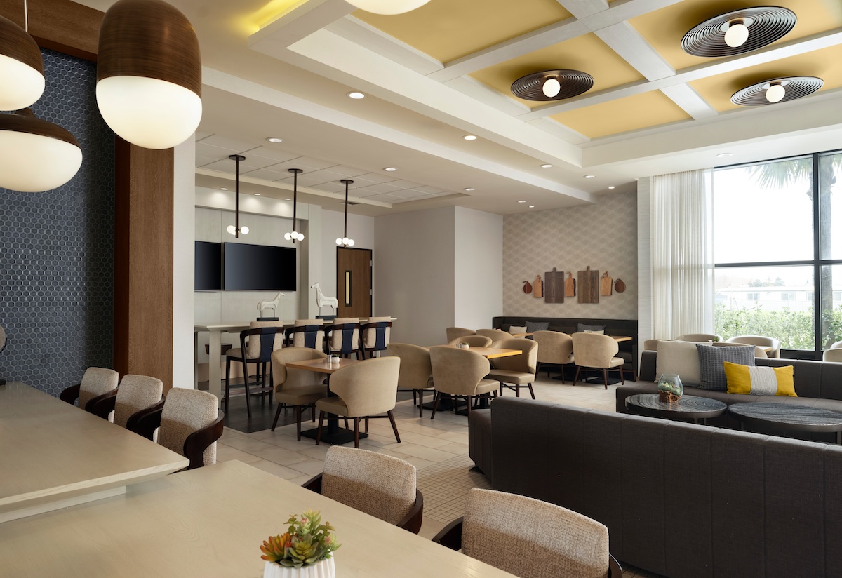 Dining area of Hotel Centro Sonoma with couch, table and bar table seating.